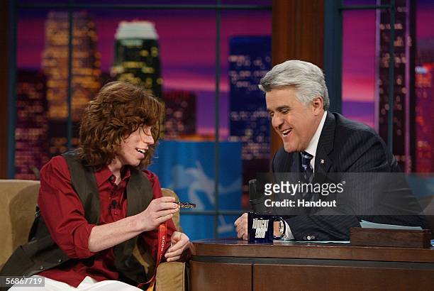 In this NBC handout photo, snowboarder Shaun White shows host Jay Leno his Olympic gold medal in the men's halfpipe event during the taping of the...