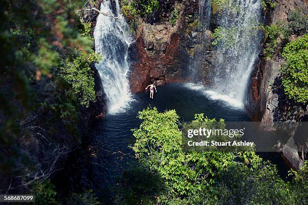 swimmer jumping in to outback swimming hole - fun northern territory stock pictures, royalty-free photos & images