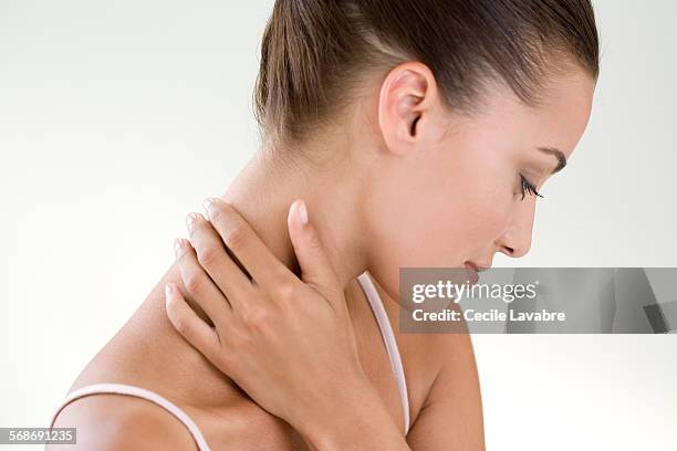 woman massaging her nape - nape neck fotografías e imágenes de stock