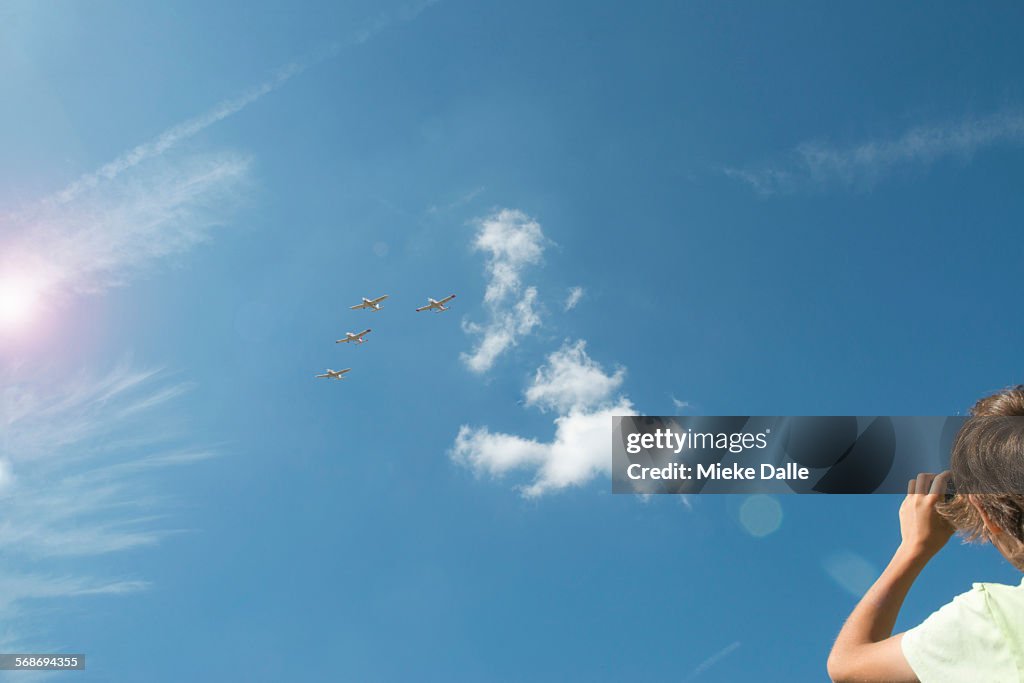 Child taking photos of airplanes