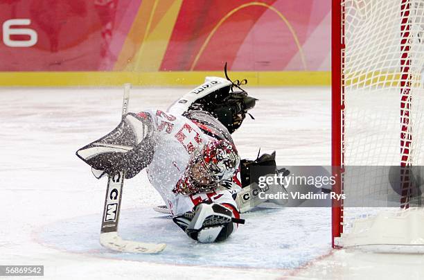 Goalkeeper Patricia Elsmore-Sautter of Switzerland fails to stop the goal by Tatiana Burina of Russia during the second period of the playoff round...