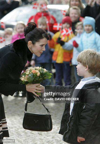 Denmark's Crown Princess Mary is welcomed by a little boy as she arrives with Crown Prince Frederik for her visit of the Kunsthalle museum 17...