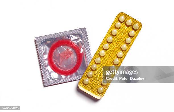 birth control pill and condom - family planning stock pictures, royalty-free photos & images