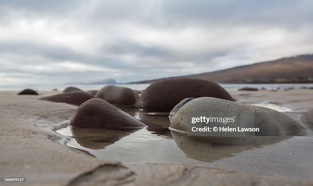 Large pebbles on sandy beach in County Mayo