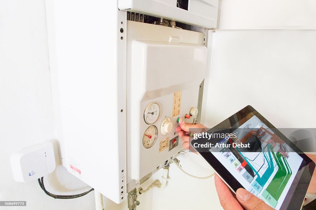 Gas technician checking installations with tablet.