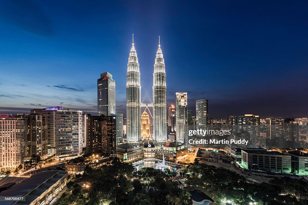 Elevated view of the Petronas Towers at dusk