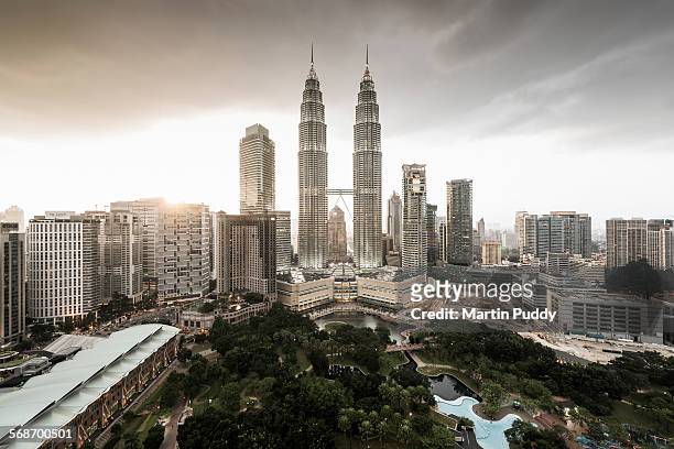 elevated view of the petronas towers at dusk - kuala lumpur stock pictures, royalty-free photos & images
