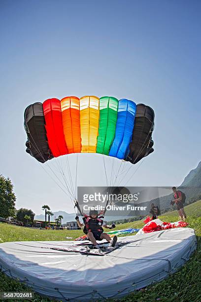 skydiver landed with the parachute on the target - landing touching down stock pictures, royalty-free photos & images