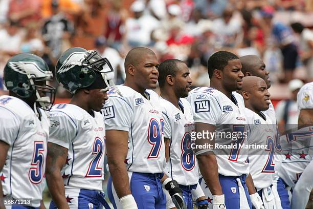 Michael Strahan, David Tyree and Osi Umenyiora of the NFC stand on the field before the 2006 NFL Pro Bowl against the AFC on February 12, 2006 at...