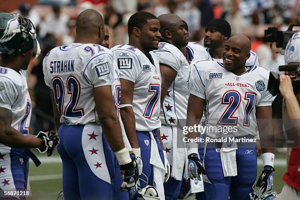 Osi Umenyiora and Tiki Barber of the NFC stand on the field before the 2006 NFL Pro Bowl against the AFC on February 12, 2006 at Aloha Stadium in...