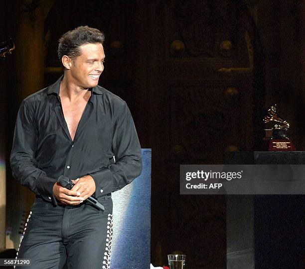 Mexican singer Luis Miguel looks at his Grammy award after his tour concert "Con Mexico en la Piel" at the National Auditorium in Mexico City 17...