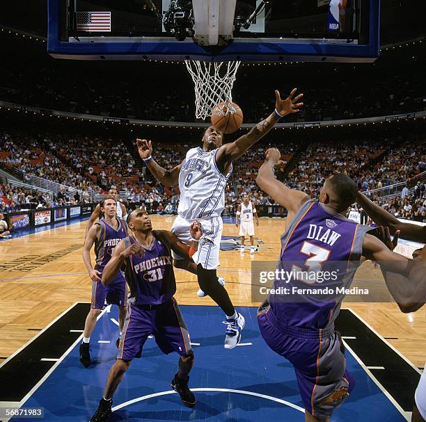DeShawn Stevenson of the Orlando Magic loses control of the ball during a game against Shawn Marion # and Boris Diaw of the Phoenix Suns at TD...