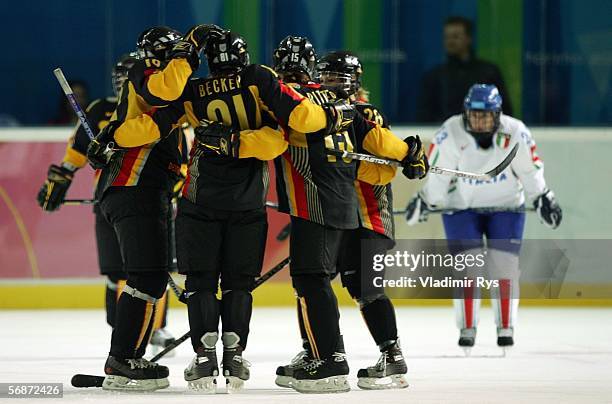 Team Germany celebrate with Maritta Becker after scoring Germany's fourth goal over Italy during the third period of the playoff round of the women's...