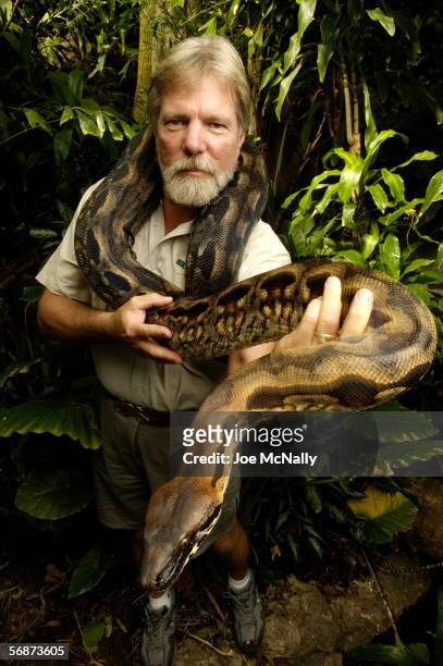 Central Park Zoo Collections manager Bruce Foster poses for a photo with a 7 foot Madagacar Boa on August 11, 2005 in New York. Zookeepers form bonds...