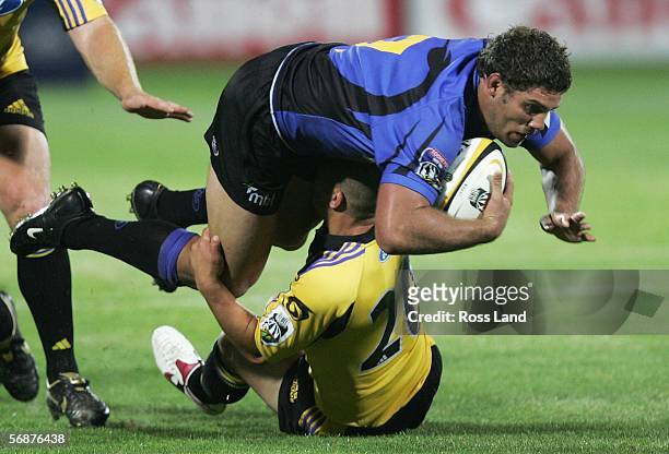 Matt Hodgson of the Western Force is tackled by Brendan Hami of the Hurricanes during the Round 2 Super 14 rugby match between the Hurricanes and the...