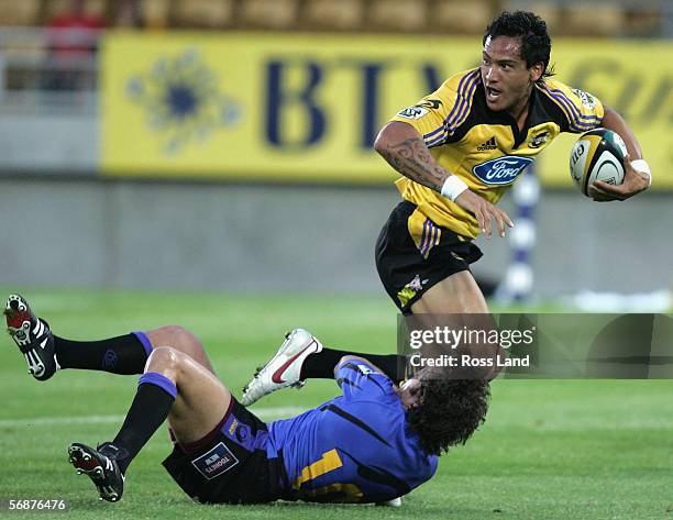 Hosea Gear of the Hurricanes runs into the tackle of Brock James during the Round 2 Super 14 rugby match between the Hurricanes and the Western Force...