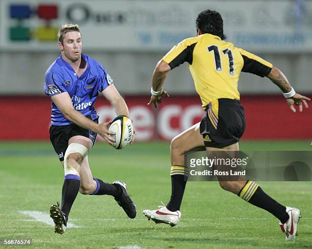 James Hilgendorf of the Western Force passes the ball past Tane Tu'ipulotu during the Round 2 Super 14 rugby match between the Hurricanes and the...