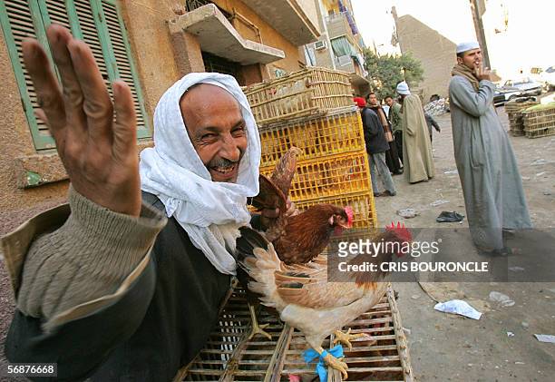 An Egyptian man sells chicken in a street market in Cairo 18 February 2006, less than a day after the first cases of bird flu had been detected in...