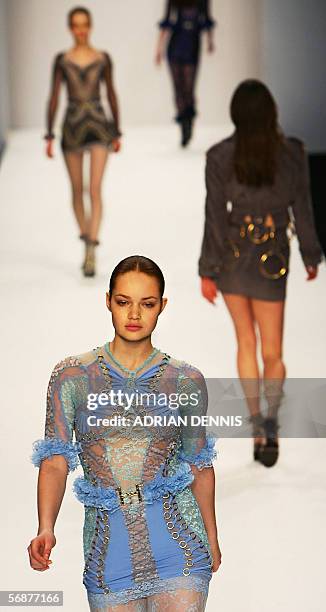 London, UNITED KINGDOM: Models present clothes by student designer Christopher Kane during the Central St. Martins College of Art & Design show at...