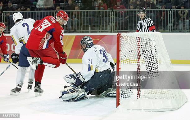 Alexei Yashin of Russia pressures goalkeeper Vitaliy Yeremeyev of Kazakhstan during the men's ice hockey Preliminary Round Group B match during Day 8...