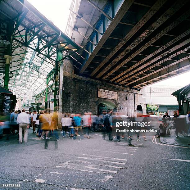 old railway bridge running over borough market - borough market stock pictures, royalty-free photos & images