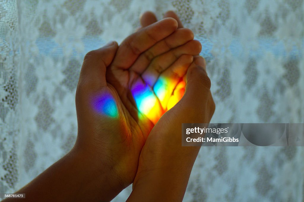 Rainbow light in her hands