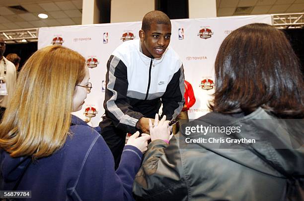 Chris Paul of the New Orleans/Oklahoma City signs autographs at a press conference at the Toyota Stage at Jam Session during NBA All Star Weekend on...