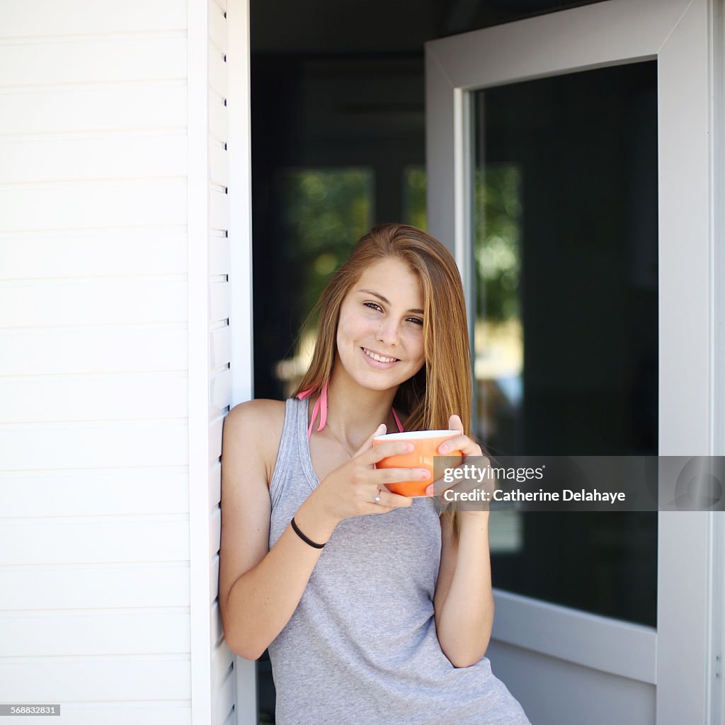 A 14 years old girl with a bowl in her hands