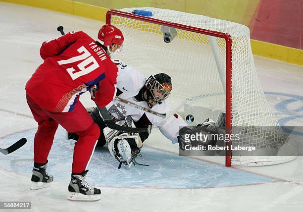 Alexei Yashin of Russia scores past Goalkeeper Sergejs Naumovs of Latvia during the men's ice hockey Preliminary Round Group B match between Russia...