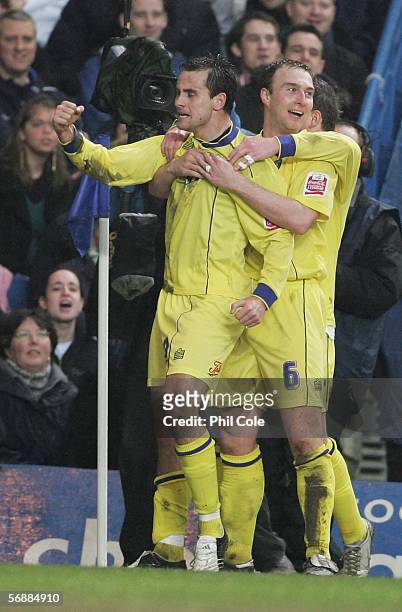 Richard Garcia and Kevin Watson of Colchester United celebrate as Ricardo Carvalho scores own goal during the FA Cup Fifth Round match between...