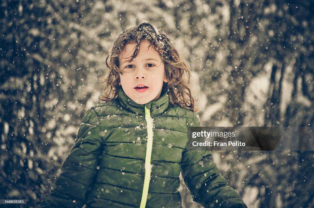 Young boy outside in the snow