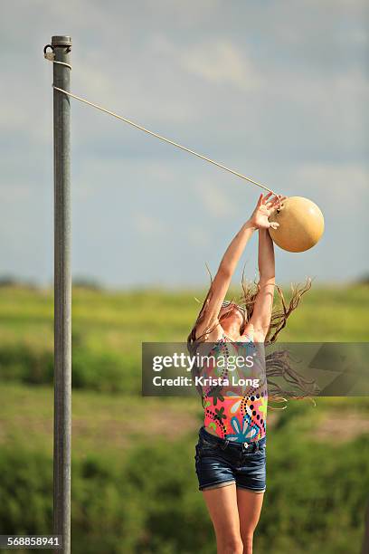 girl playing tetherball. - tether ball stock pictures, royalty-free photos & images
