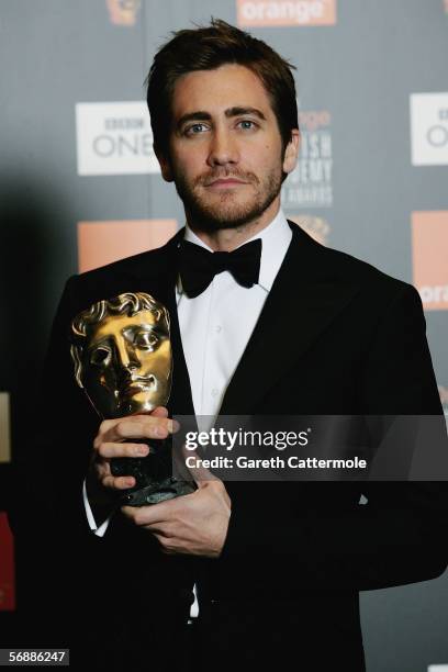 Jake Gyllenhaal poses backstage in the Awards Room with the award for Best Actor in a Supporting Role for 'Brokeback Mountain' at The Orange British...