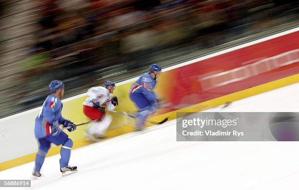 Member of Team Czech Republic skates aginst a member of Team Italy during the men's ice hockey Preliminary Round Group A match during Day 9 of the...