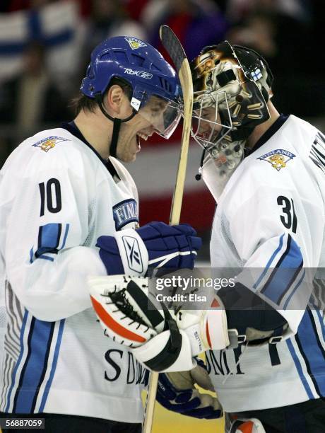 Ville Nieminen of Finland celebrates defeating Canada 2-0 with teammate goalie Antero Niittymaki in the men's ice hockey Preliminary Round Group A...