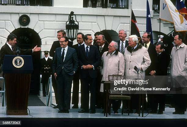 President Reagan speaks before signing the Social Security Amendments Act of 1983 on the south lawn on April 20, 1983. Among those present are: Dan...