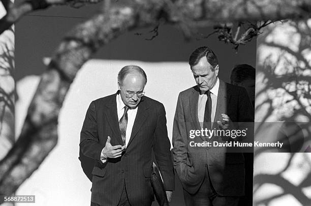 President George H.W. Bush and Secretary of Defense Dick Cheney discuss the run up to Operation Desert Storm as they walk near the Rose Garden at the...