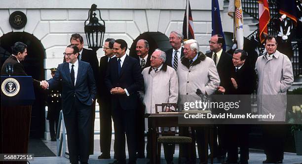 President Reagan speaks before signing the Social Security Amendments Act of 1983 on the south lawn on April 20, 1983. Among those present are: Dan...