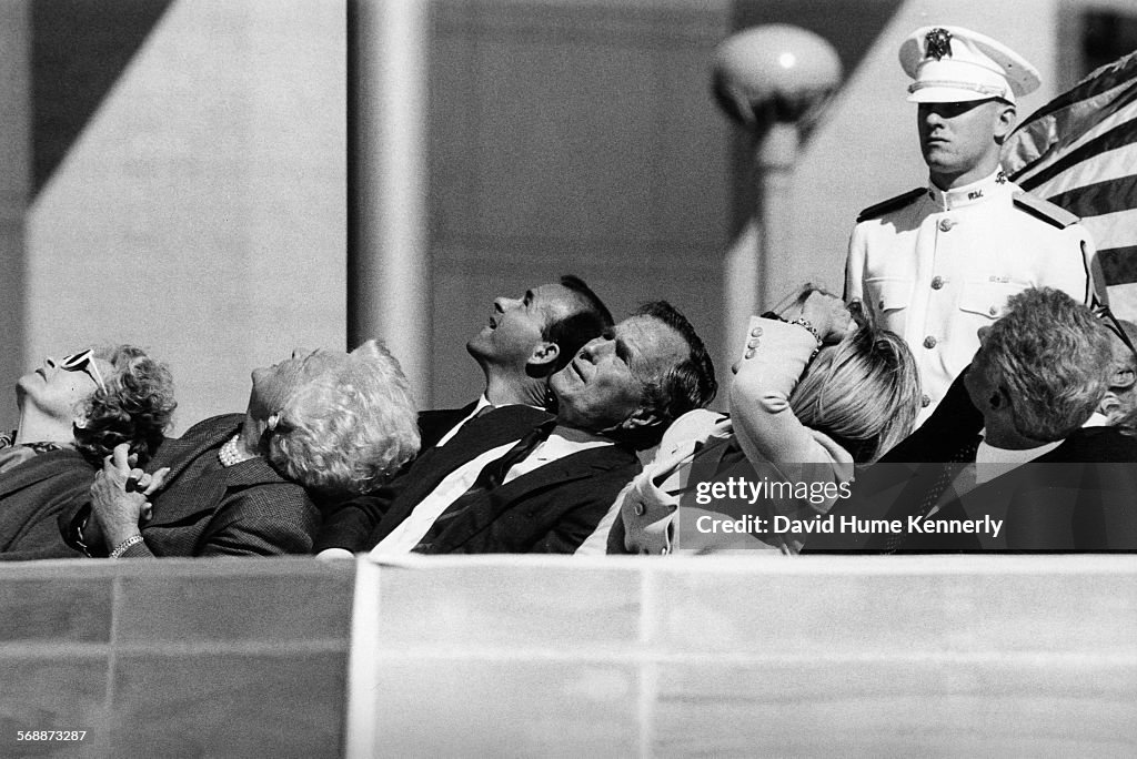 Former President George H.W. Bush and guests watches a parachute demonstration at the dedication of his Presidential Library