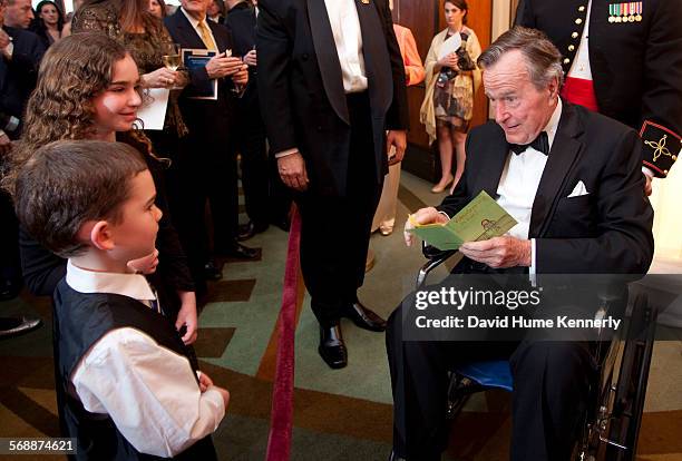 Former President George H.W. Bush talks with a young fan at The Points of Light Tribute at the Kennedy Center, Washington, D.C., March 21, 2011.