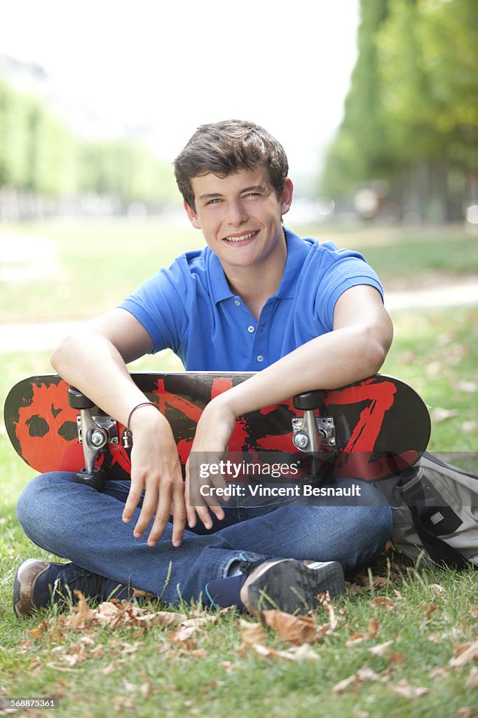 Portrait of a young man with his skateboard