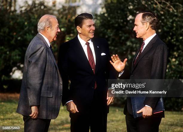 President Ronald Reagan with Vice President George H.W. Bush and Secretary of State George Shultz outside the Oval Office at the White House in 1984...