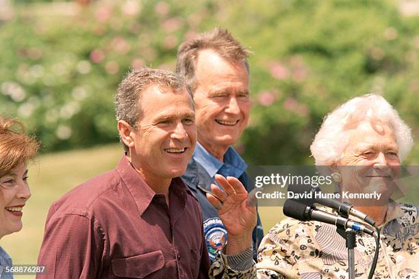 Laura Bush, Governor George W. Bush, U.S. President George H. Bush and his wife Barbara Bush meet the press at Walkers Point the President's summer...