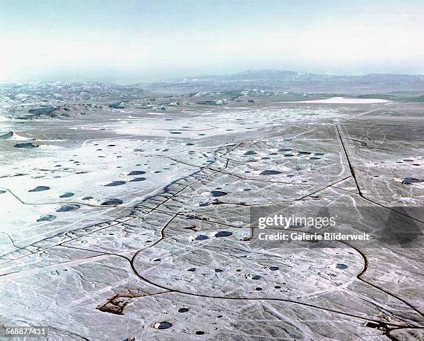 The crater-scarred landscape of the Nevada Test Site. Most subsidences leave saucer-shaped craters are varying in diameter. 1995. This is the north...