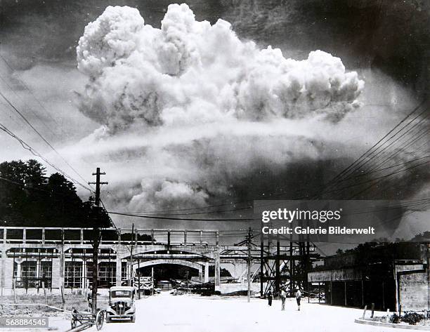 The atomic bomb mushroom cloud over Nagasaki seen from Koyagi-jima. 9th August 1945. The plutonium implosion-type bomb was dropped off a Boeing B-29...