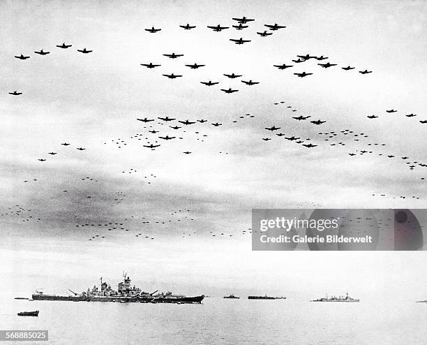 Navy carrier planes fly in formation over the U.S. And British fleets in Tokyo Bay during the Japanese surrender, 2nd September 1945. USS Missouri ,...