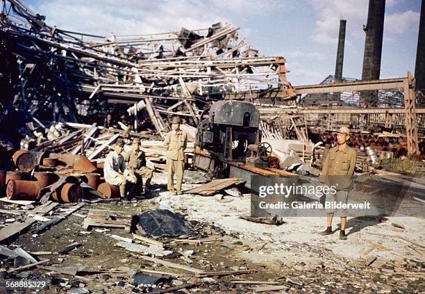 Japanese soldiers in Nagasaki amid the devastation caused by the dropping of the atomic bomb on August 9, 1945. The plutonium implosion-type bomb was...