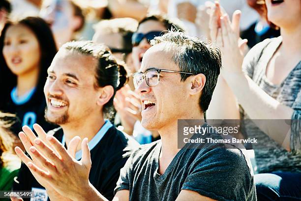 man clapping during soccer match in stadium - fan fest day 2 stock-fotos und bilder