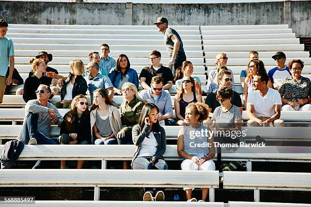 crowd of sports fans gathering in stadium - people in stadium seats stock pictures, royalty-free photos & images