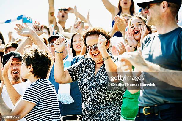 senior woman celebrating during soccer match - liberty stadion stock pictures, royalty-free photos & images